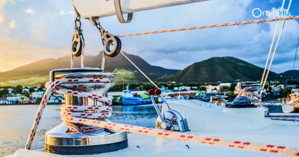 Sailboat winch overlooking a harbor at sunset, highlighting OrbitsHubs maritime technology insights
